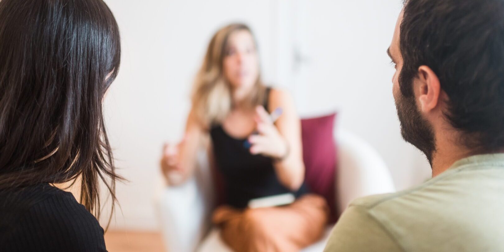 Blurred couple carefully listening to their psychologist in order to solve their problems